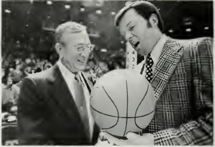 John Wooden presented with the game ball after UCLA's record 61st consecutive win, 1973